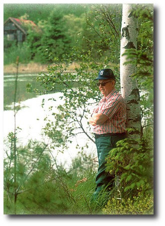 Uncle Johnnie at Shear Lake, tarpaper shack in background