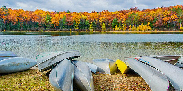 Boats by Shear Lake in the fall at Camp Barakel